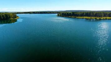 A serene lake with a small island in the center. Bright, natural lighting to emphasize the calm water. video