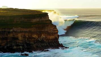 Aerial shot A dramatic coastline with rugged cliffs and crashing waves. Bright, natural lighting to highlight the dramatic scenery video