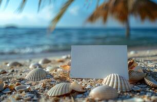 Blank card on a sandy beach with seashells, ocean waves, and a palm tree in the background photo