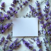 Blank card mockup on a marble background, surrounded by fresh lavender flowers. Perfect for invitations, greetings, and stationary designs. Elegant and minimalistic with a natural, floral photo