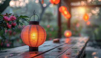 Traditional chinese lantern glows warmly on wooden table in garden at dusk photo