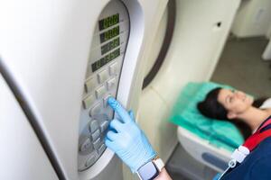 Radiologist with a female patient in the room of computed tomography. photo
