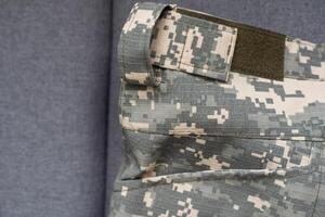 Ukraine Army uniform insignia badges on camouflaged uniform background. photo