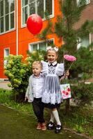 portrait of a cute little seven year old first-grader girl with her brother photo