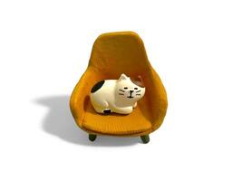 Miniature toy of cat on the chair isolated on white photo