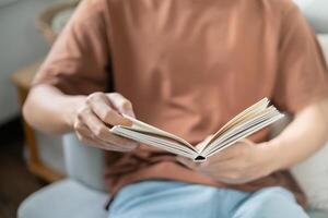Men reading book and relaxing at home and comfort in front of opened book photo