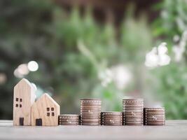 Miniature house, Stack of coins with virtual increasing graph and percentage icons. The concept of price of house, Property investment, House mortgage, Real estate photo
