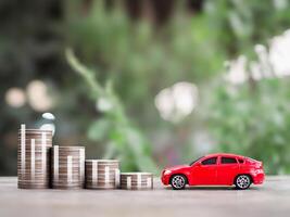 Toy car, Stack of coins with virtual increasing graph. The concept of saving money and manage to success transport business photo
