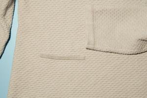 Texture of a knitted sweater with a fragment of a sleeve and a pocket photo