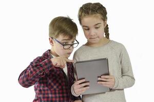 Boy and a girl are view at a new application or a game on a tablet. New on the tablet. On a white background photo