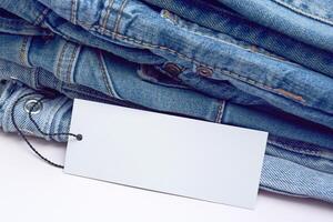 Lots of jeans pants in a stack. Denim background. photo