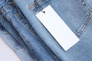 Lots of jeans pants in a stack. Denim background. photo