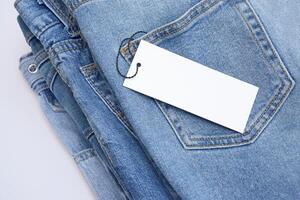 Lots of jeans pants in a stack. Denim background. photo