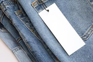 Lots of jeans pants in a stack. Denim background. photo