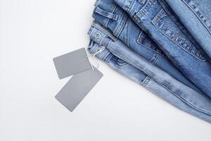 Lots of jeans pants in a stack. Denim background. photo
