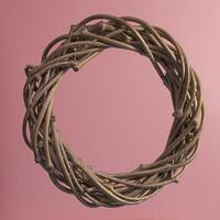 Christmas wreath on a pink background, made of twigs with gilding. Square format. Close-up, texture. photo