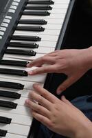 Piano music lessons. two hands playing chords and scales exercizes. Synthesizer keyboard close-up. photo