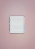 Open small notebook with blue and beige bookmarks on peach background photo