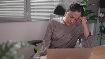 Stressed woman working at dawn Woman full of fatigue while using computer in empty office overworked video