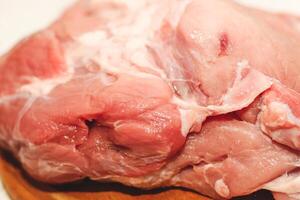 Fresh piece of meat large pork ham on a board with pepper. photo