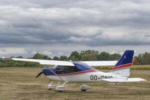 Hasselt. Limburg - Belgium 27-08-2022 A single-engine aircraft against the backdrop of a stormy sky. Public show of vintage aircraft on the grass airfield at the Hasselt Aero Club photo