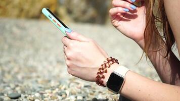 Woman Using Her Smartphone on the Beach video