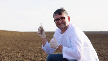 Senior scientist checks the quality of the soil for control soil quality before seed plant. Future agriculture concept. Smart farming, using modern technologies in agriculture video