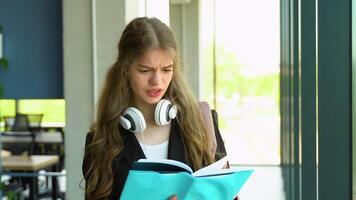 Anxious girl feeling tired while studying at school. Troubled and stressed girl doing exam that doesnt know the answers video