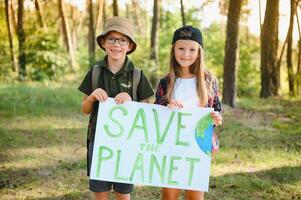 Children are holding a poster Save the planet. Earth Day. Let's save the planet from pollution. photo
