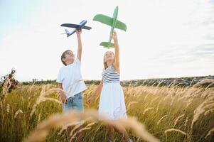 Active running kids with boy holding airplane toy. photo