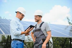 engineer and businessman planing new ecology project. around solar panel photo