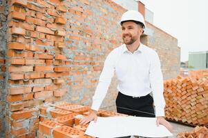 A construction worker controlling the construction of roof structures on construction site photo