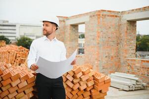 Construction concept of Engineer working at Construction Site with blue print. photo