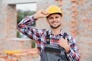 Construction worker in uniform and safety equipment have job on building. Industrial theme photo