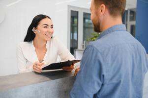 Excellent service. Nice friendly woman talking to the client while standing at the reception. photo