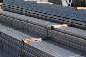Stack of rolled metal products, perspective view of steel pipes of rectangular cross-section photo