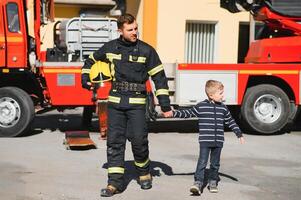 Protect people from dangerous with brave heart.Hero in fireman with uniform safe children from burn smoke photo