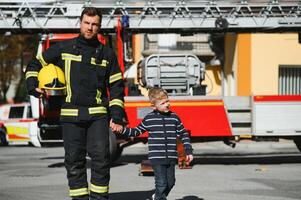 Protect people from dangerous with brave heart.Hero in fireman with uniform safe children from burn smoke photo