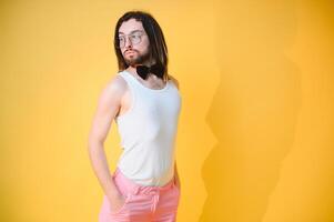 Young, handsome gay man on a colored background in the studio. LGBT concept. photo