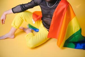 Youth transgender LGBT with Rainbow flag on shoulder isolated color background. gender expression pride and equality concept. photo