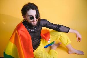 Youth transgender LGBT with Rainbow flag on shoulder isolated color background. gender expression pride and equality concept. photo