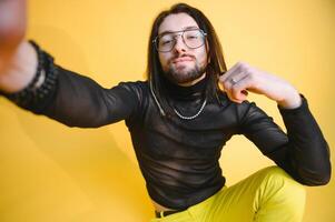 Young, handsome gay man on a colored background in the studio. LGBT concept. photo