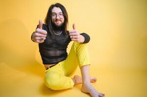 Young, handsome gay man on a colored background in the studio. LGBT concept. photo