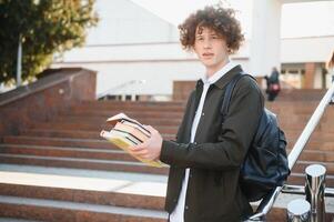 Excited student having break between classes near university, smiling to camera outdoors photo