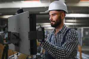 worker operating machine in factory photo