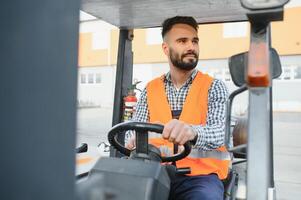 Waving forklift driver in the warehouse of a haulage company while driving forklift photo