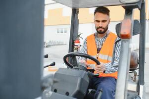 Waving forklift driver in the warehouse of a haulage company while driving forklift photo