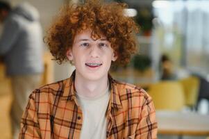 Headshot of happy redhead man, smiling excited at camera. photo
