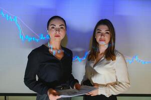 Analyzing data, graphs and reports for investment purposes. Creative teamwork traders. photo