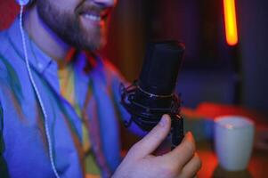 A blogger records content in his studio. The backstage photo was taken from behind one of the participants in the shooting, at the beginning of the shooting when the blogger is preparing.